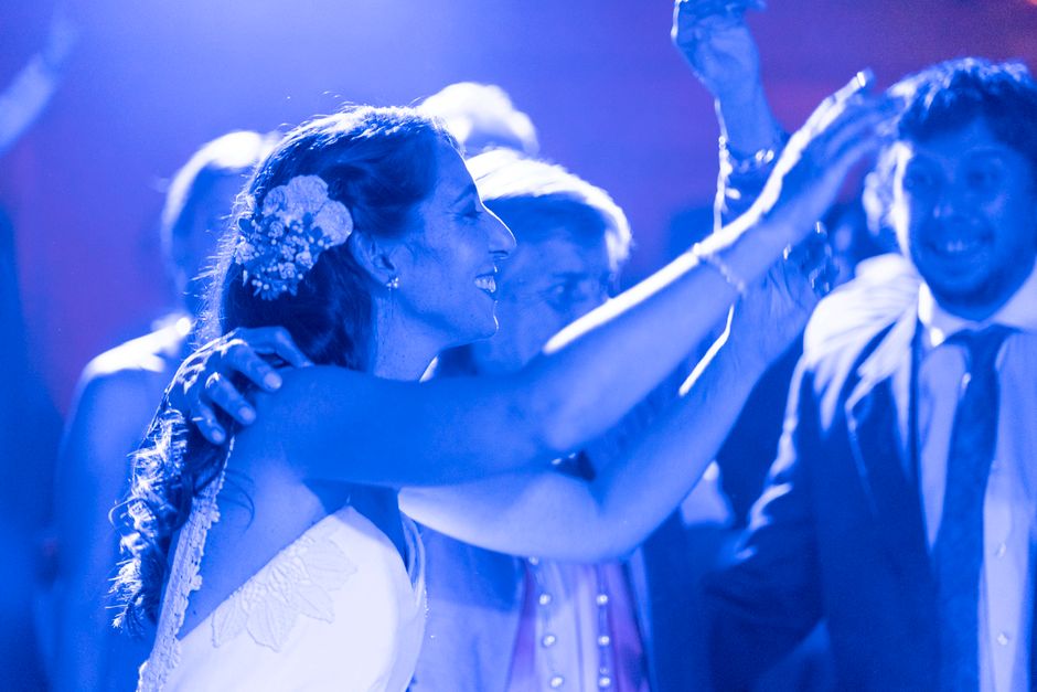 Guests celebrating and dancing energetically at a wedding reception